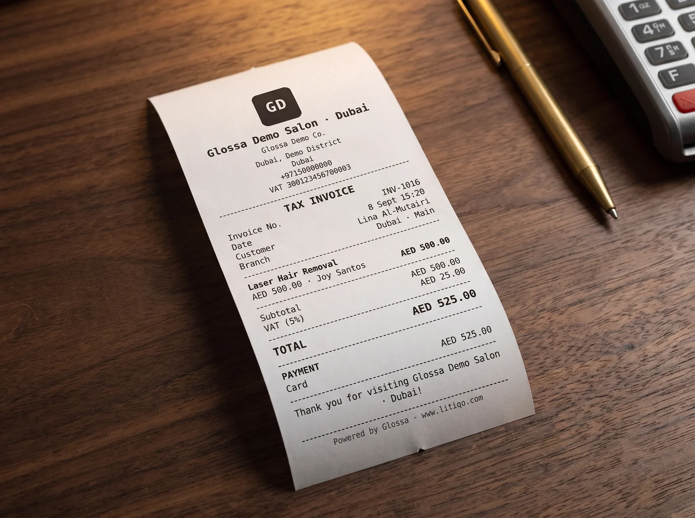 A printed 80mm Glossa tax invoice on a salon counter